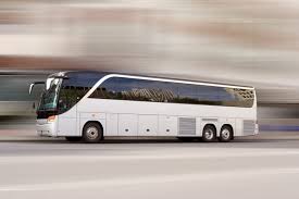 White charter bus driving